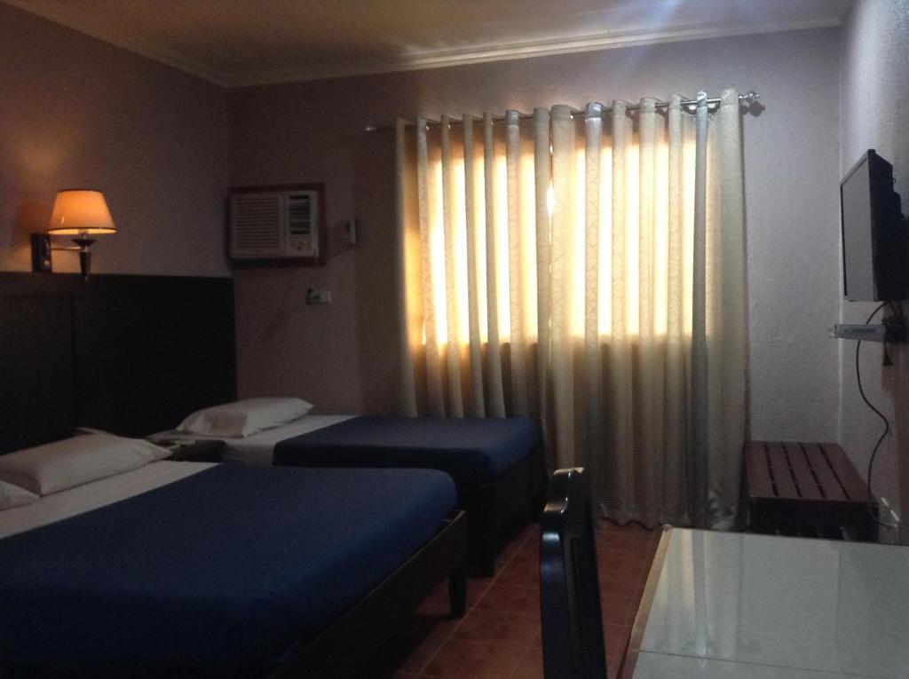 Postel nebo postele na pokoji v ubytování Miami Inn