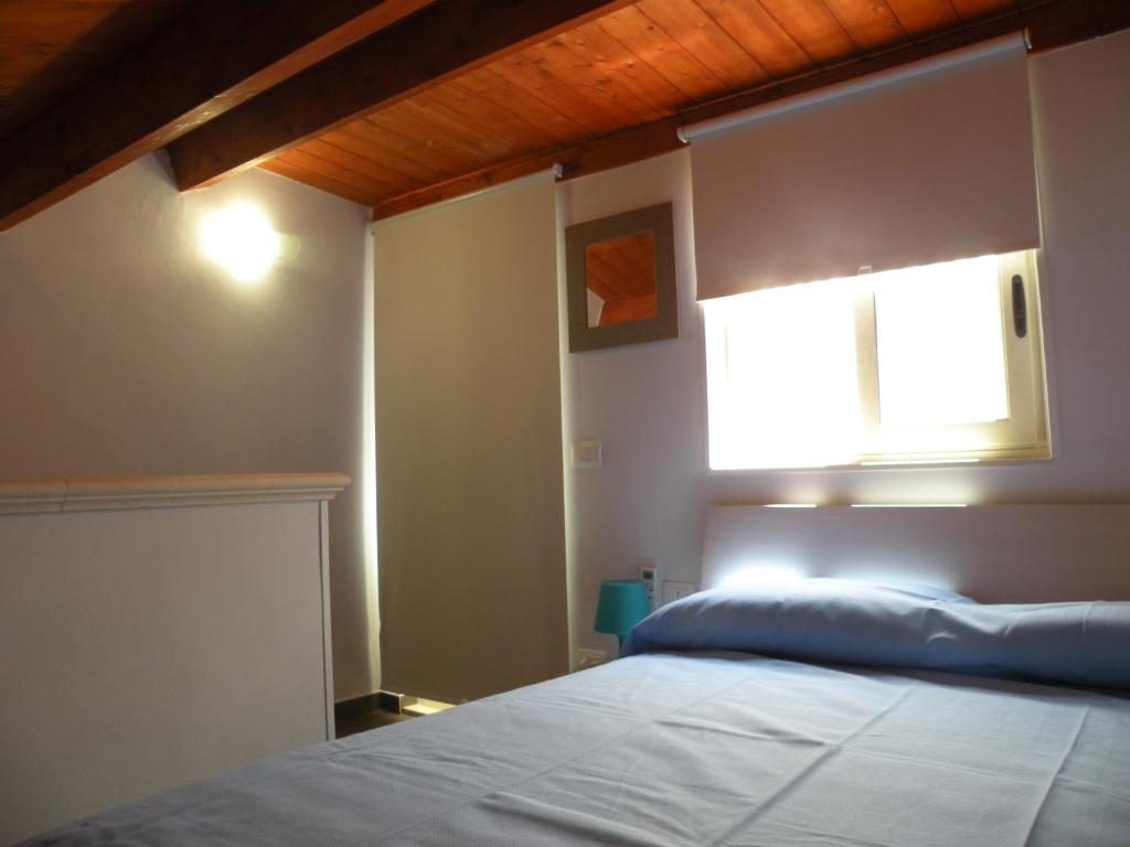 A bed or beds in a room at Al Blu Ortigia Apartments