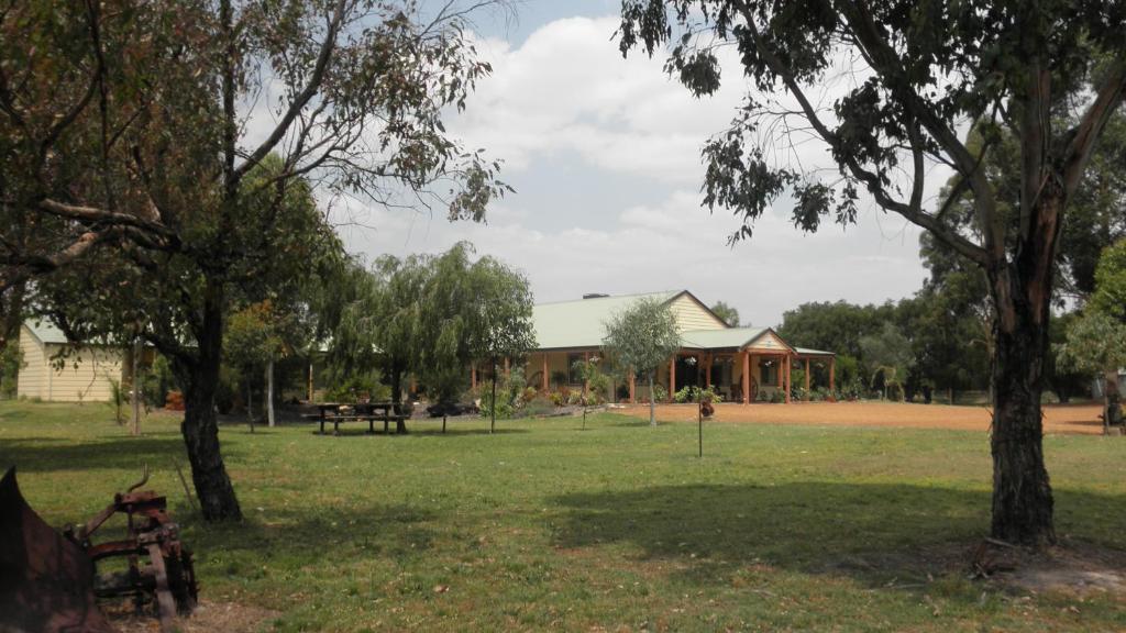 a house in a park with trees in the foreground at Enderslie House in Muchea