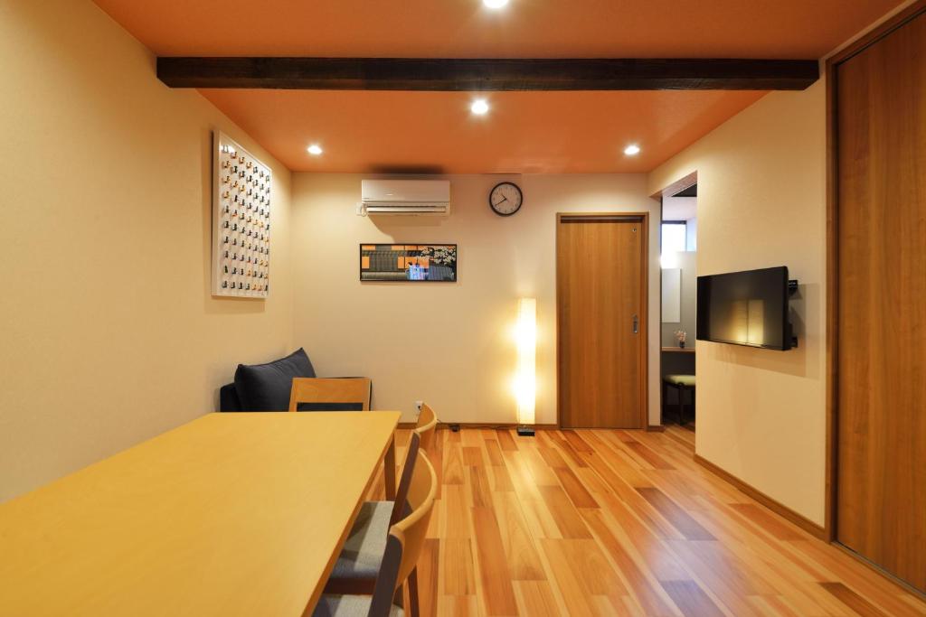 a living room with a table and a tv at Eisukeya in Gion in Kyoto