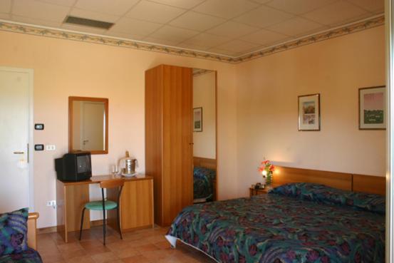 Postel nebo postele na pokoji v ubytování Villaggio Hotel Club La Pace