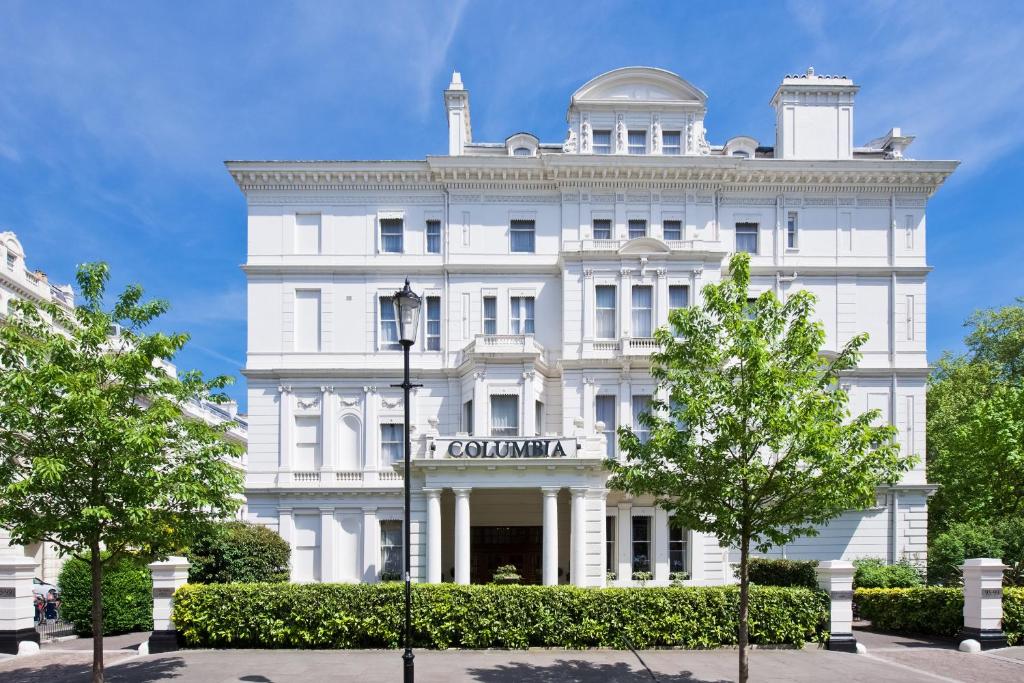 a white building with trees in front of it at The Columbia in London