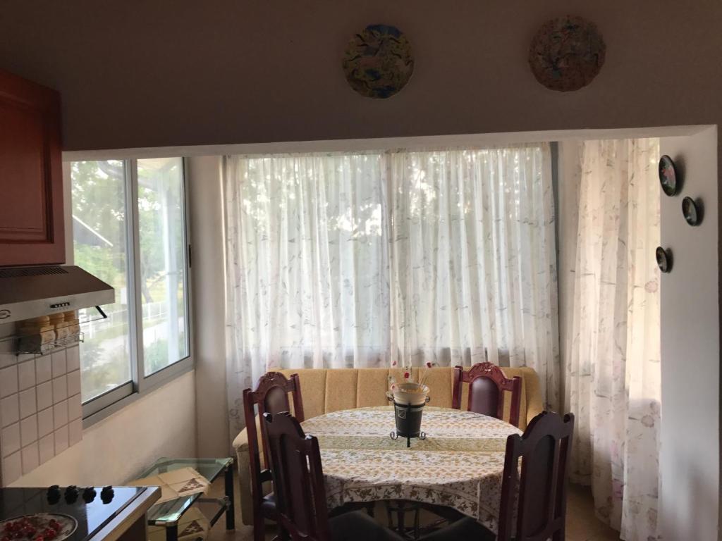 a table and chairs in a kitchen with a window at Holiday Home Zenit in Ulcinj