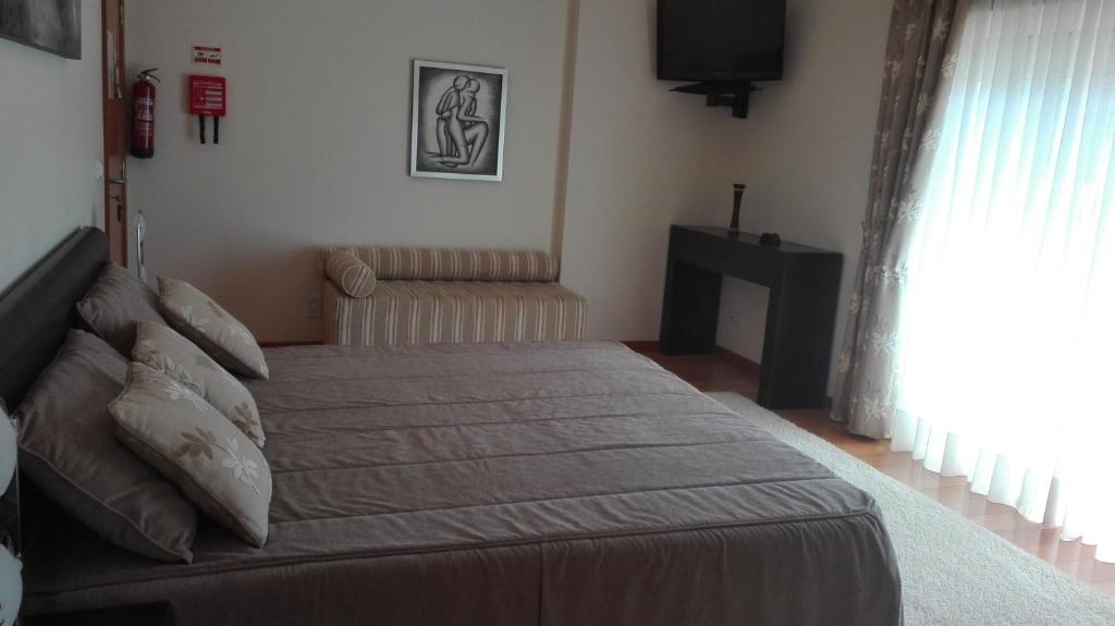 Postel nebo postele na pokoji v ubytování Quarto/Suite de Charme