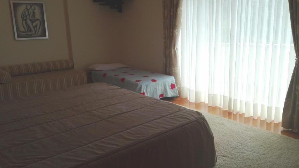 Postel nebo postele na pokoji v ubytování Quarto/Suite de Charme