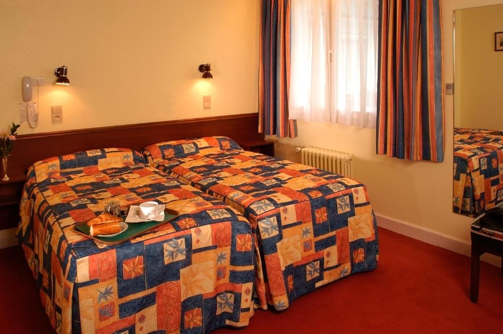 Postel nebo postele na pokoji v ubytování Hôtel Beauséjour