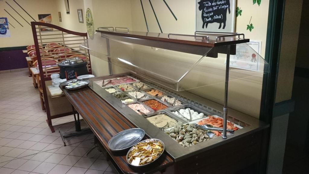 a display case with many different types of food at Le Relais De Risquetout in Hem-Hardinval