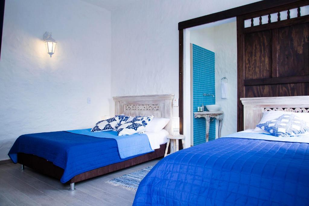 Llit o llits en una habitació de Hotel Mulato