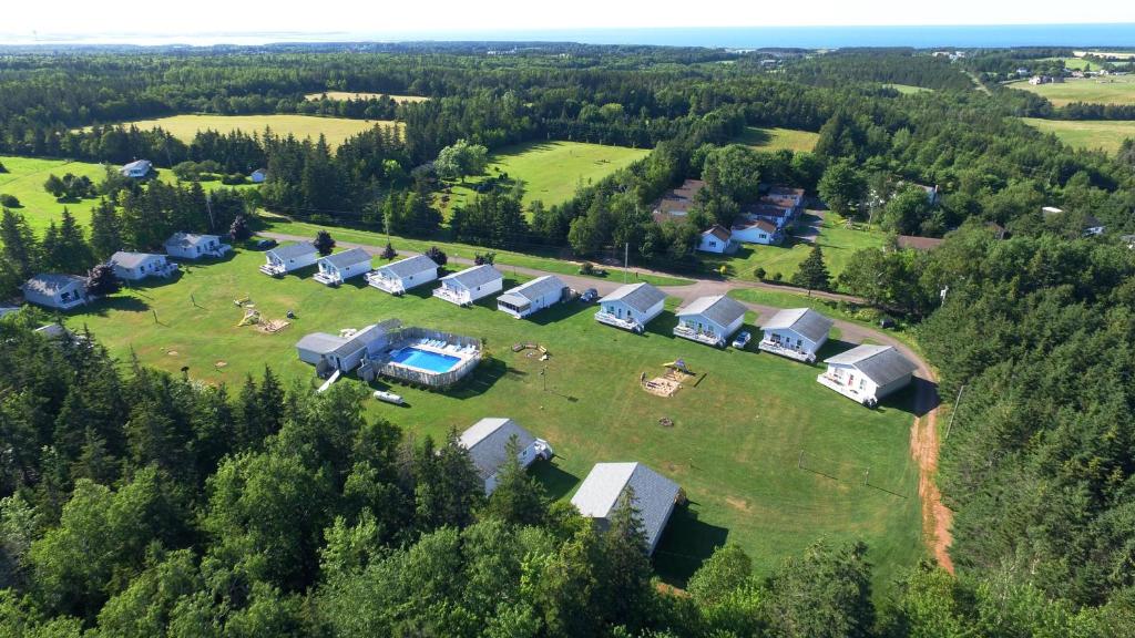 an aerial view of a group of houses on a field at Hidden Acres Cottages in Cavendish