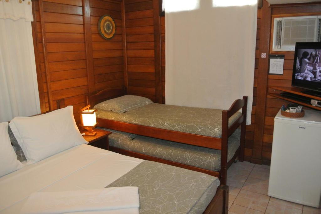 Cama ou camas em um quarto em Complexo de Pousadas Caraguatá