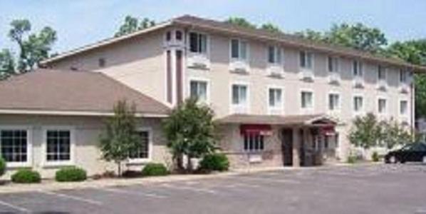a large brick building with a large window at Budget Host Inn & Suites North Branch in North Branch