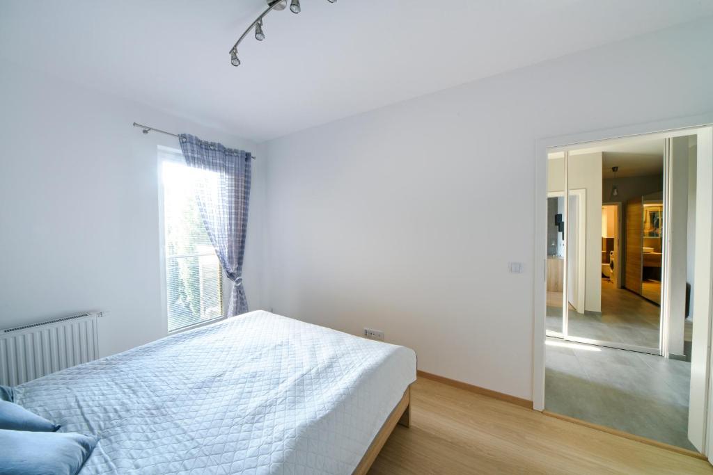 Postel nebo postele na pokoji v ubytování Apartamenty City View od WroclawApartament-pl
