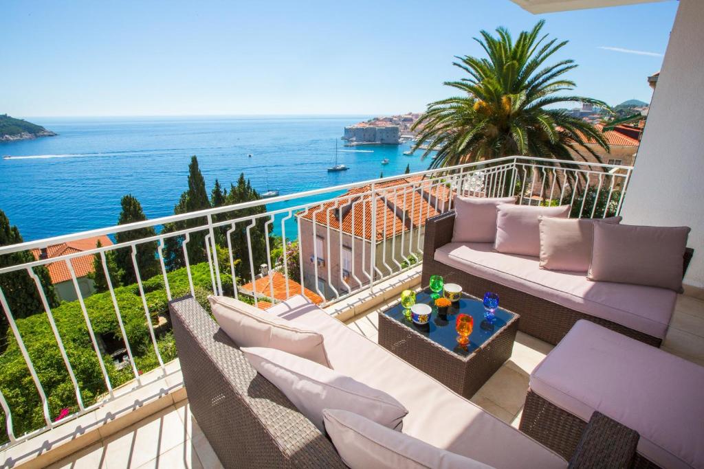 a balcony with couches and a view of the ocean at Ambassador Suite Dubrovnik in Dubrovnik