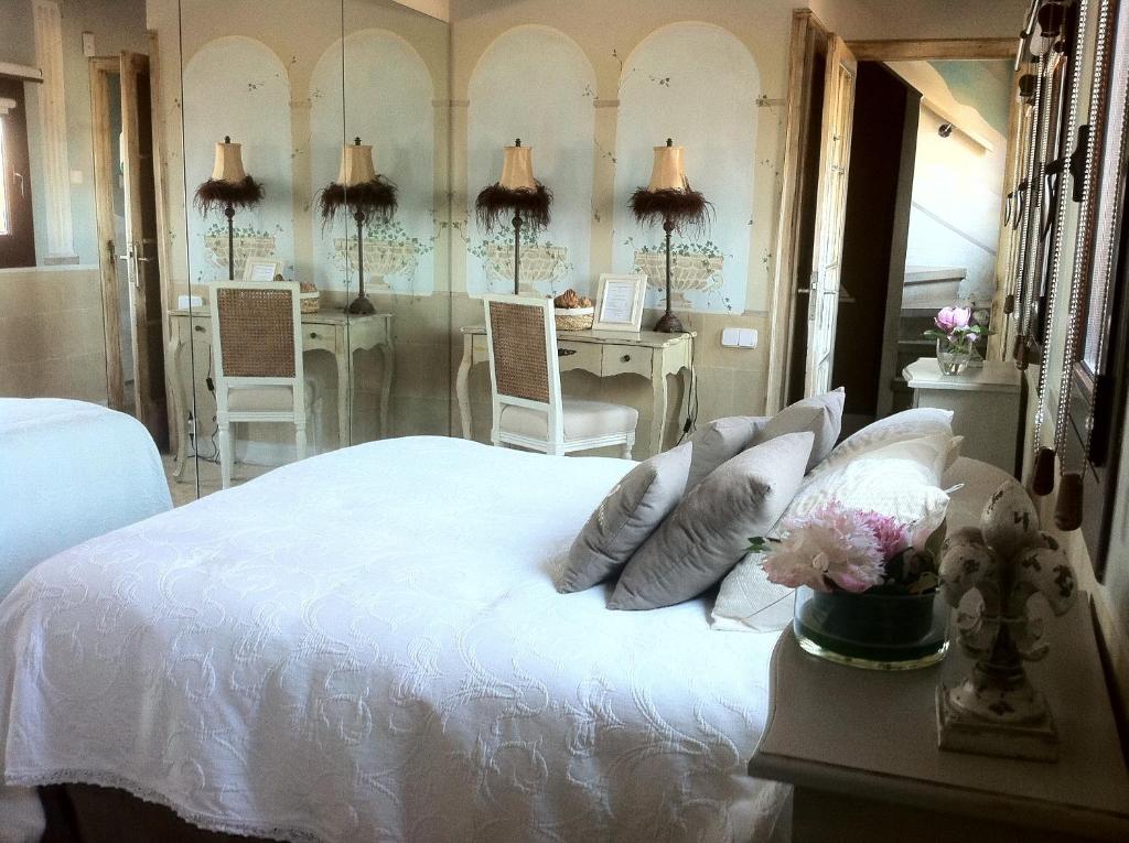 
a hotel room with two beds and a table at Boutique Hotel Davallada- Adults Only in Sitges
