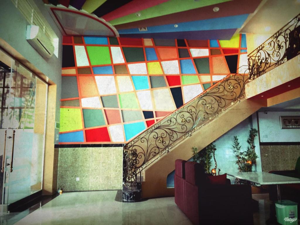 a staircase in a building with a colorful wall at Soben Sensok Guesthouse in Phnom Penh