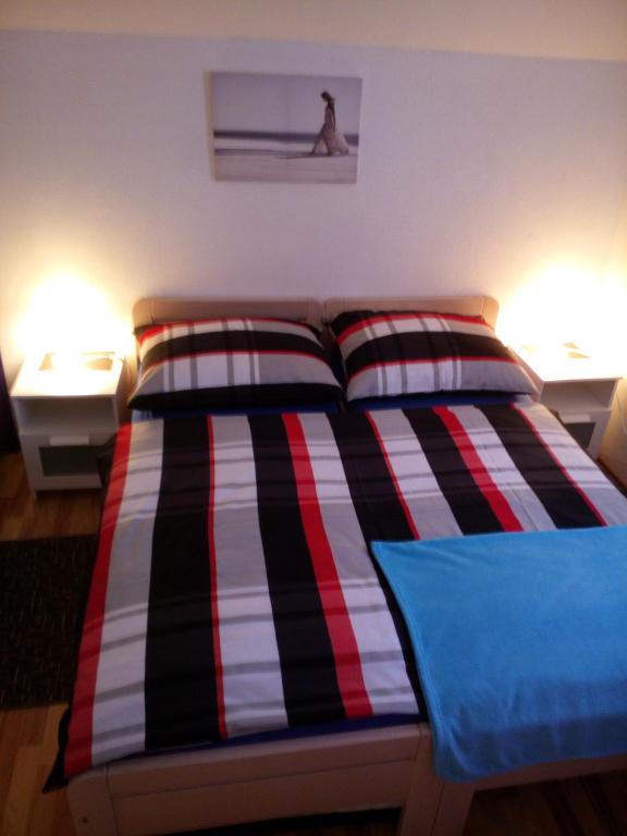 a bed with two pillows on it in a room at Rooms Marina in Korenica