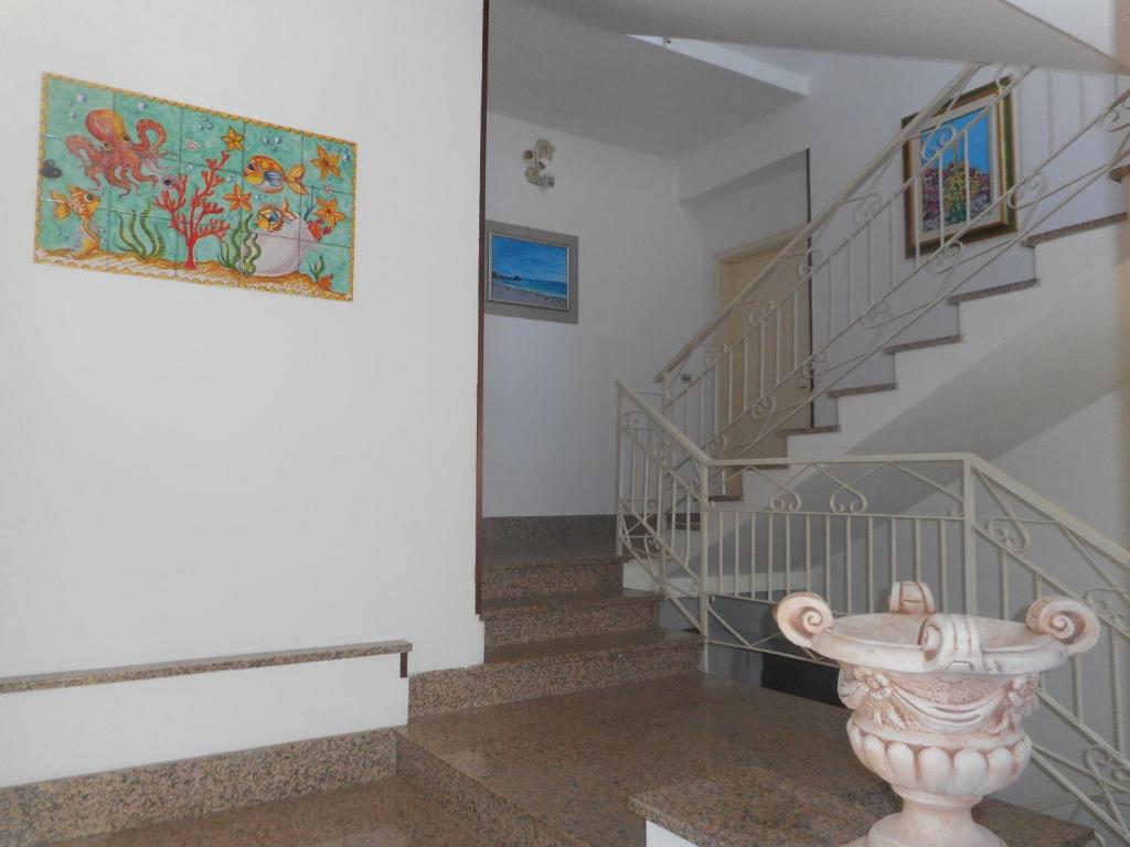 a staircase with a vase in the middle of a room at B&B Stella Marina in Soverato Marina