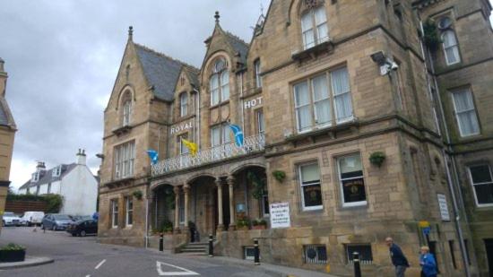 a large stone building on a city street at The Royal Hotel Tain in Tain