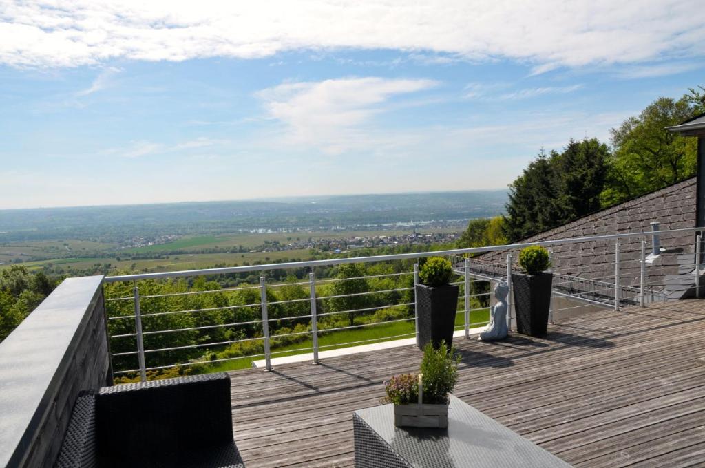 a deck with a view of the countryside from a house at Zum Rebhang Bed & Breakfast in Oestrich-Winkel