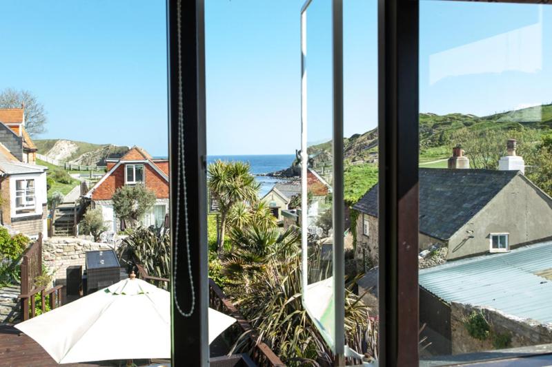 a view of the ocean from a window at Lulworth Lodge in Lulworth Cove