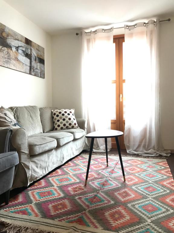 a living room with a couch and a table at Appartamento Carducci in Madesimo