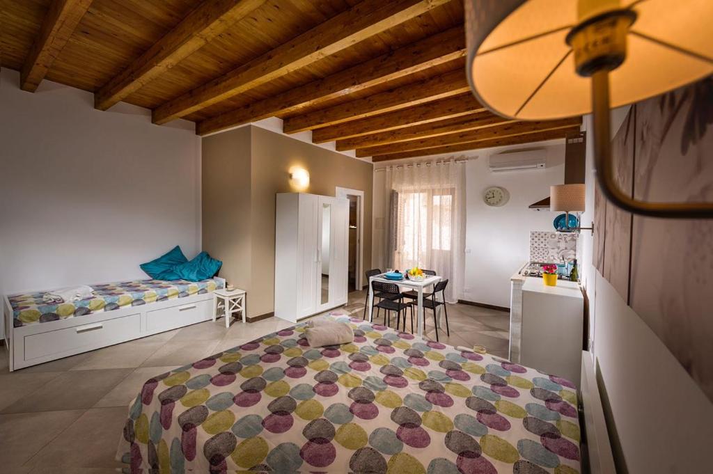 a bedroom with a bed and a table in it at Il Cortile in Castellammare del Golfo