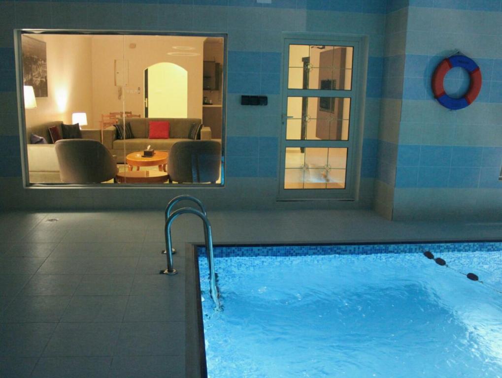 a swimming pool with a view of a living room at Dshale Chalets in Taif