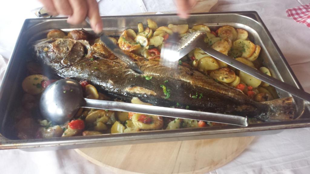 a tray of food with a fish and vegetables at Restaurant &amp; rooms Visovac - best value in Skradin