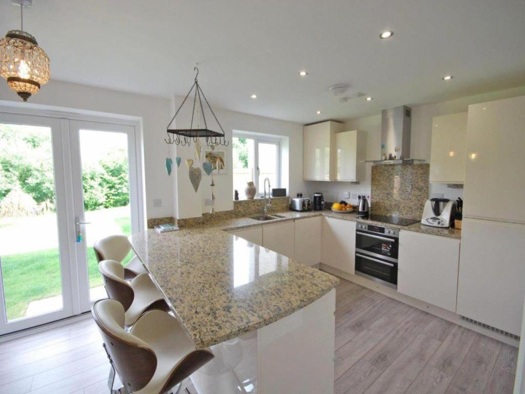 a kitchen with a marble counter top and a island at Luxurious House in Cornwall in Truro