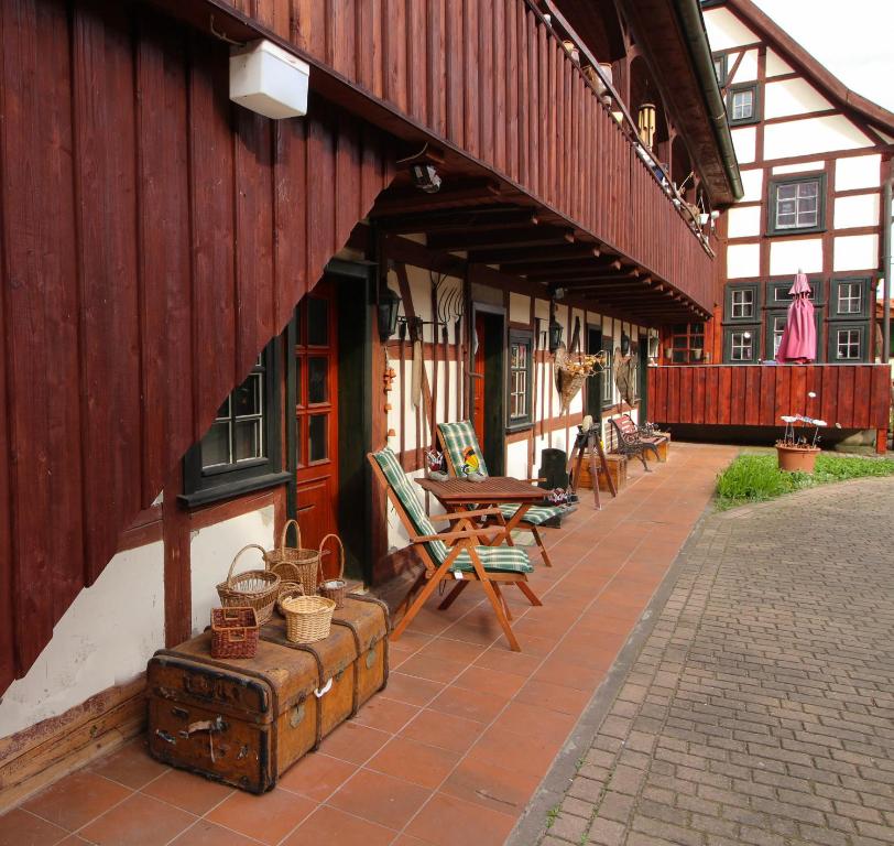 a building with a patio with tables and chairs at Hotel Erfurter Kreuz in Kirchheim