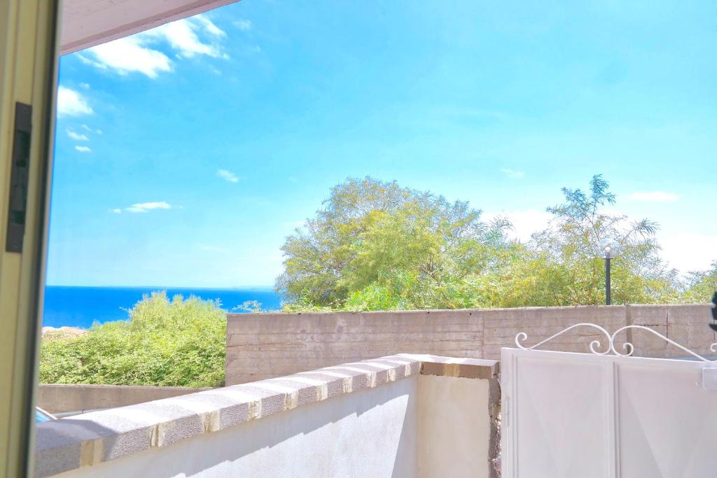 a view of the ocean from the balcony of a house at Villa Alba in Acitrezza