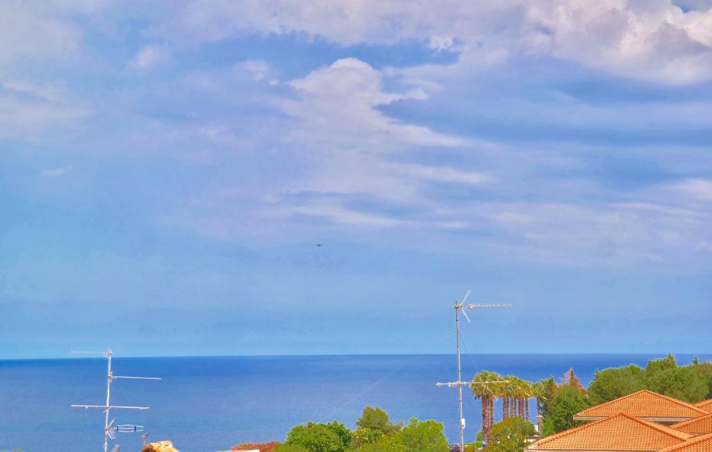 a view of the ocean and a blue sky with clouds at Villa Alba in Acitrezza