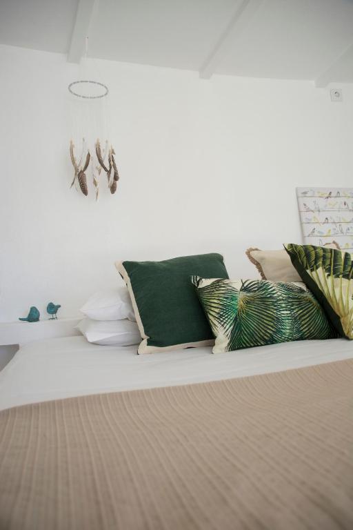 a living room with pillows on a couch at O Moinho da Roca in Azoia