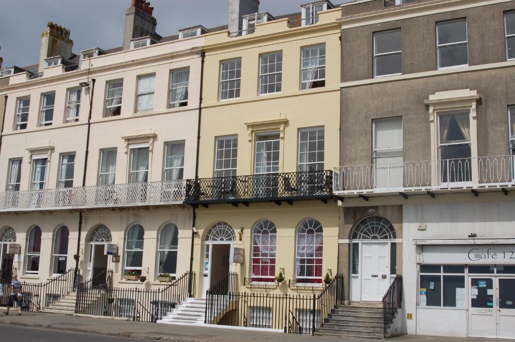 an apartment building on the corner of a street at The Edenhurst Guesthouse in Weymouth