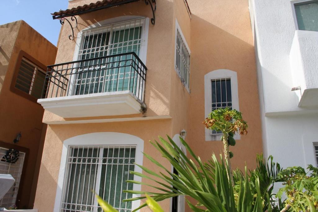 a building with windows and plants in front of it at Residencial Gran Santa Fe Cancun in Cancún