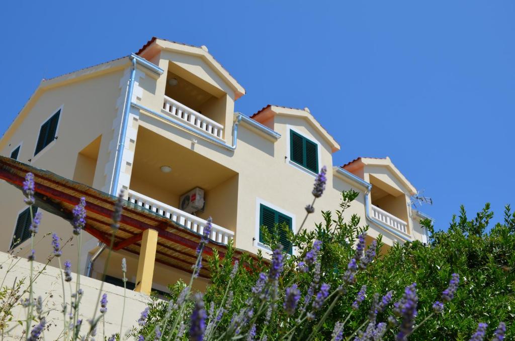 a building with purple flowers in front of it at Villa ForTudor in Milna