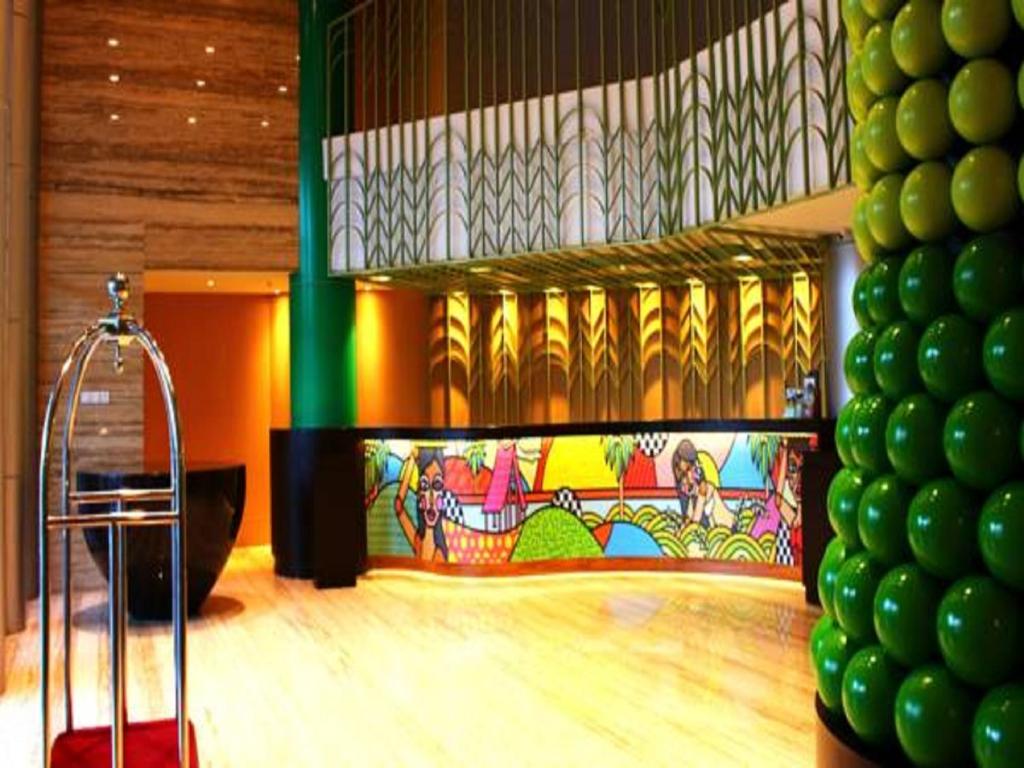 a room with a dance floor with a colorful wall at G'Sign Style Hotel in Kuta