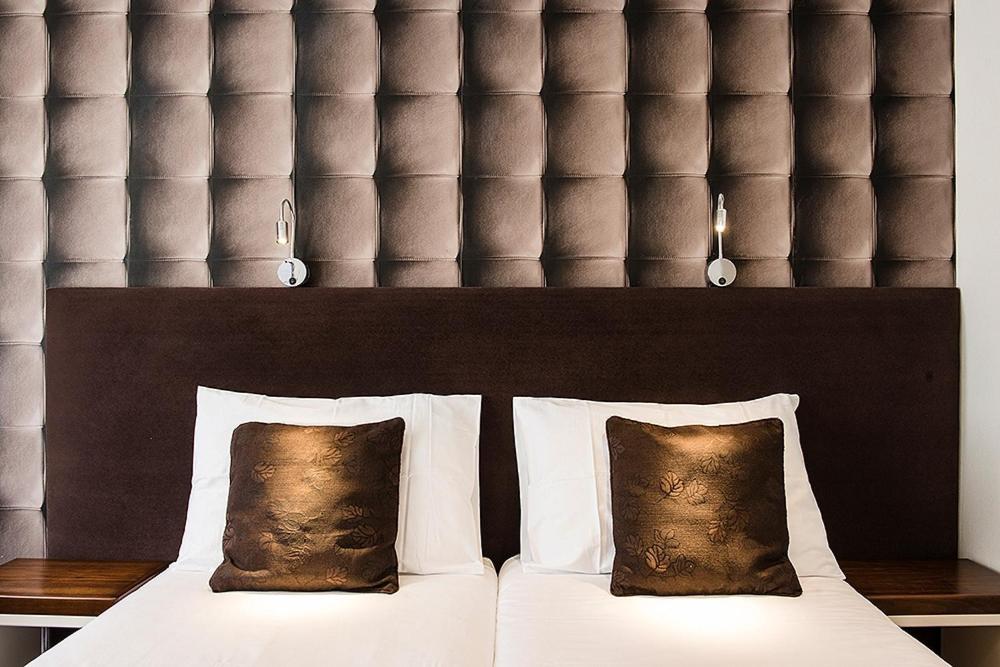 Ένα ή περισσότερα κρεβάτια σε δωμάτιο στο Hotel Alpha
