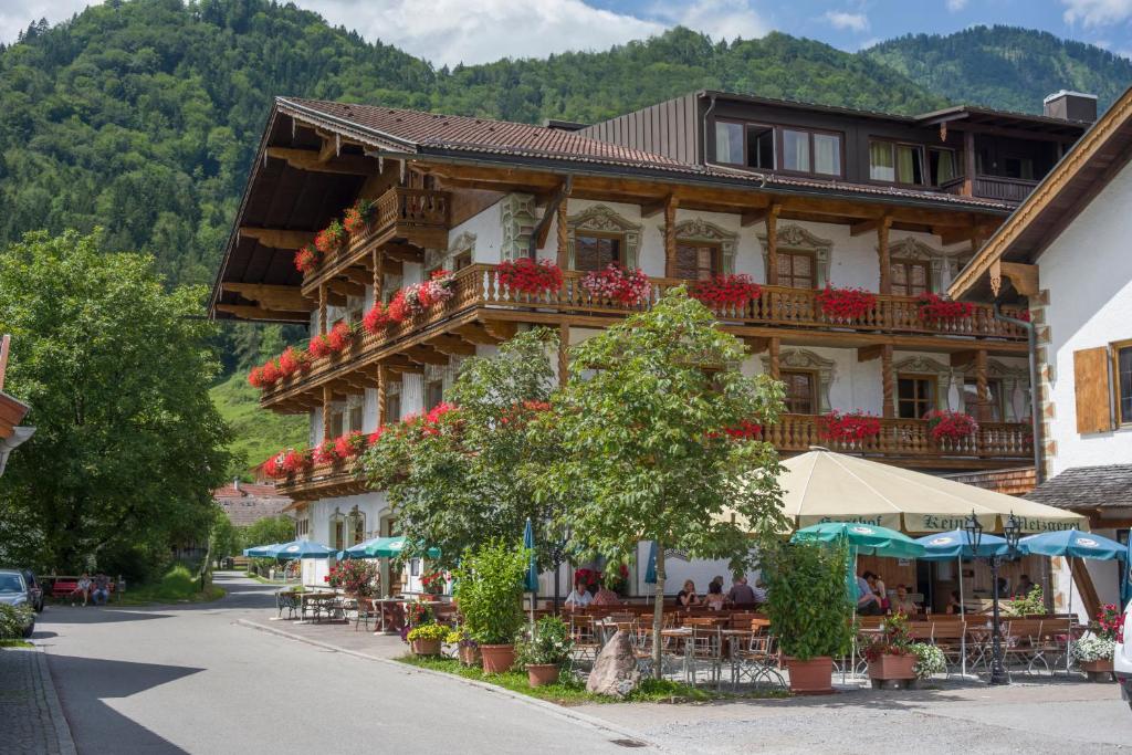 a building with tables and chairs in front of it at Hotel Keindl in Oberaudorf