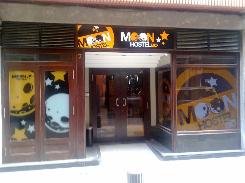 a store front with halloween signs on the windows at Moon Hostel Bio in Bilbao