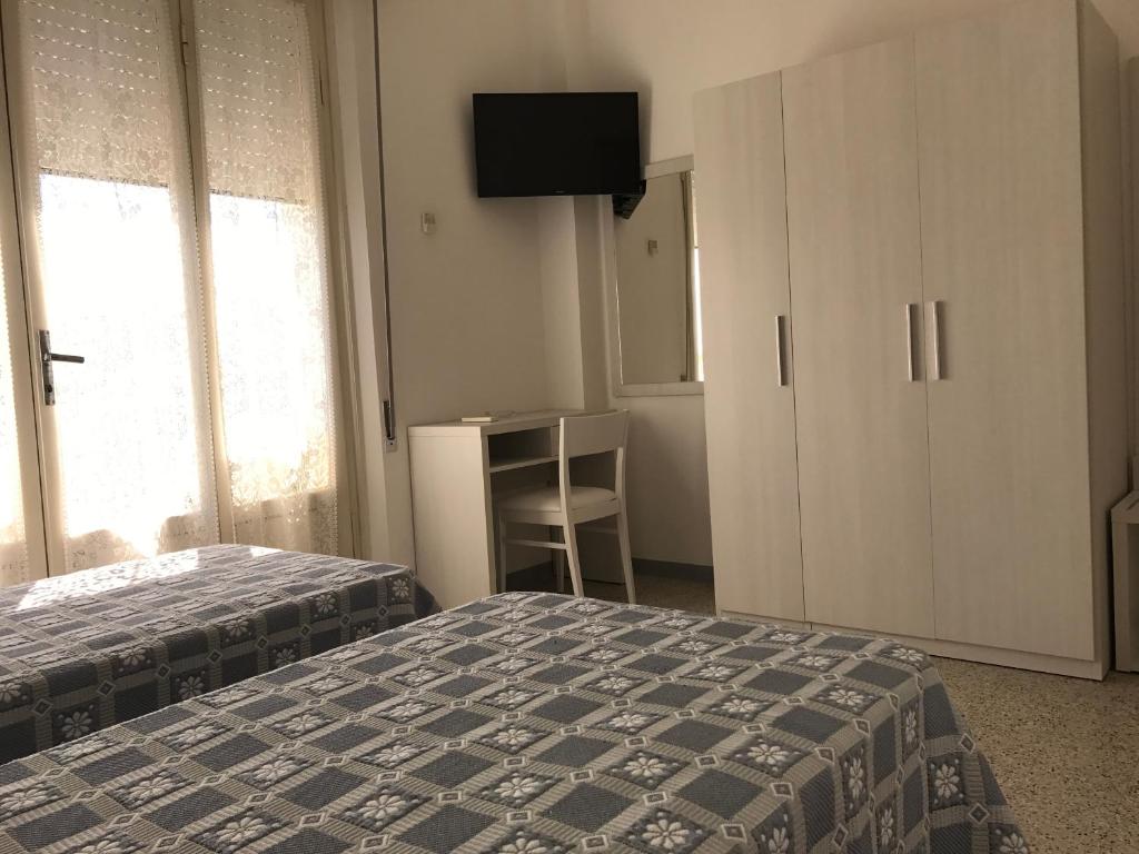 Postel nebo postele na pokoji v ubytování Hotel Annita Cervia