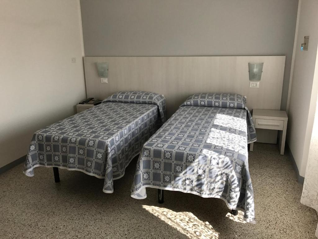 Postel nebo postele na pokoji v ubytování Hotel Annita Cervia