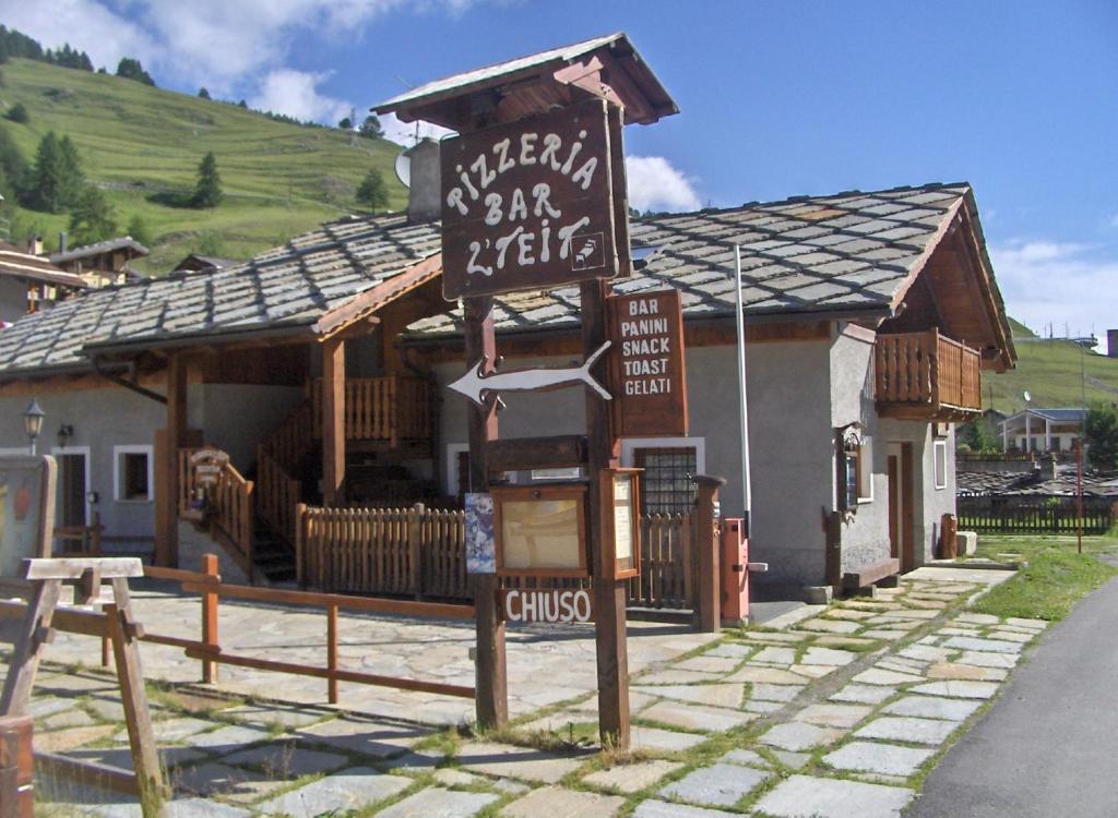 a building with a sign in front of it at Residenza L'Teit in Sestriere