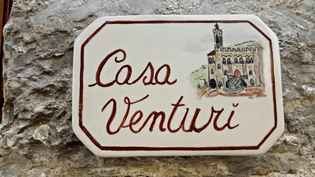 a sign on a wall with the wordscal venturi at Casa Venturi in Gubbio