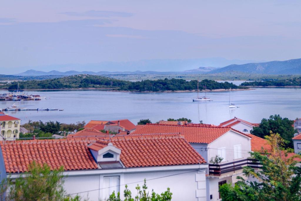 a view of the water and roofs of buildings at Apartment Stella in Murter