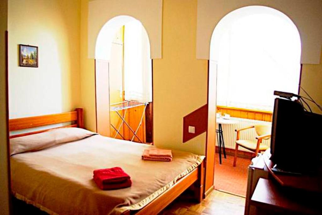 Postel nebo postele na pokoji v ubytování Malvy hotel
