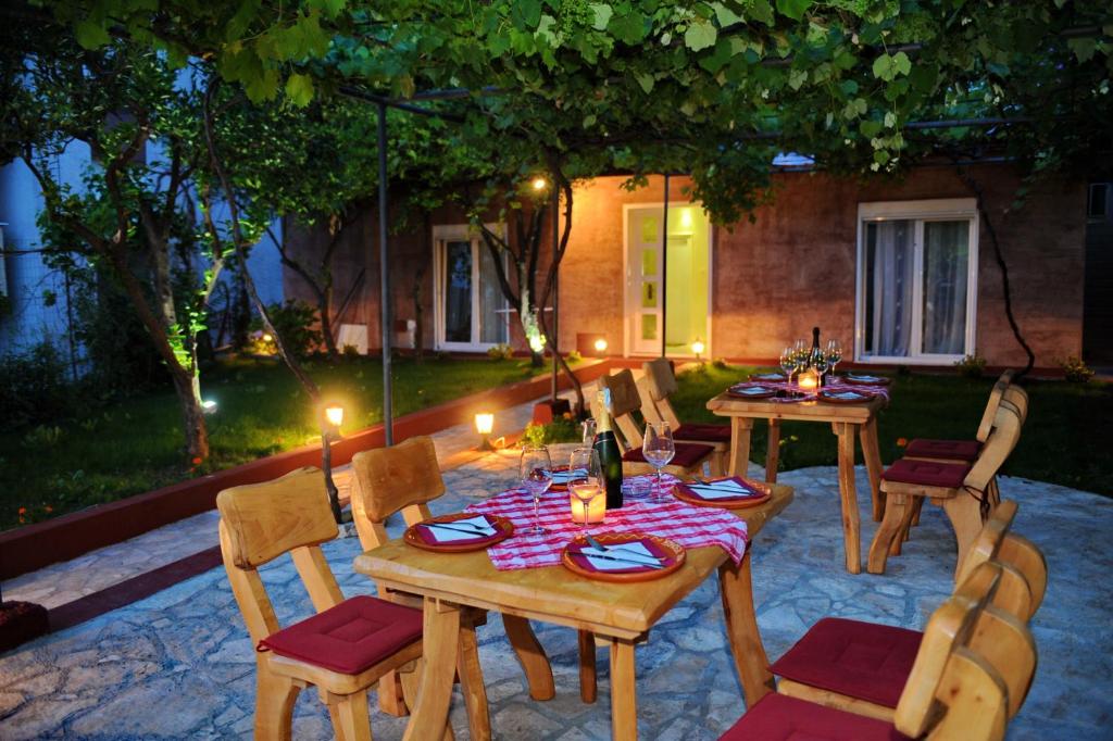 a patio with two tables and chairs with candles at Apartments Amigo in Kotor
