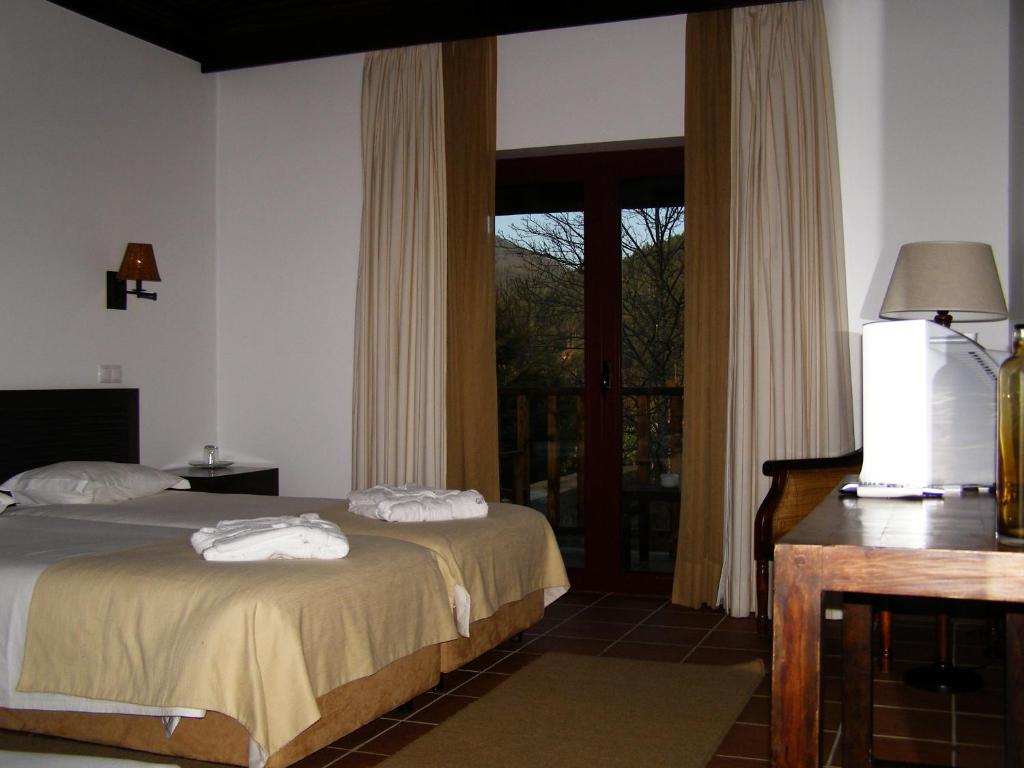 Uma cama ou camas num quarto em Hotel Rural Quinta de Novais