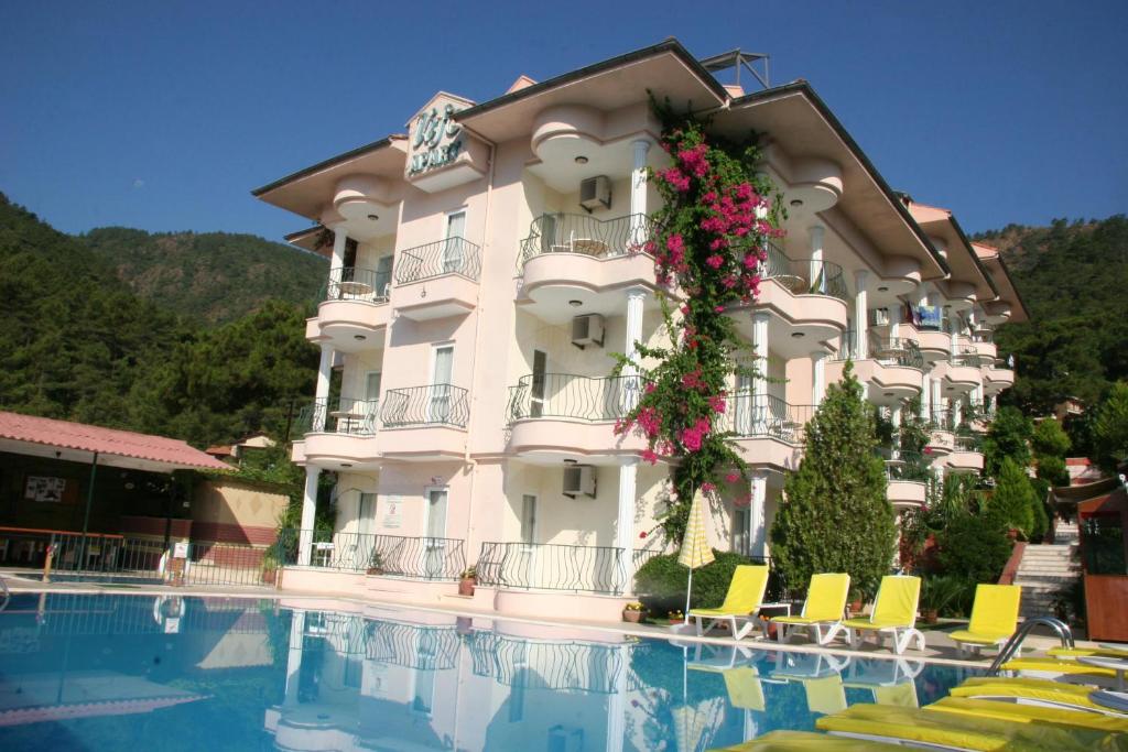 a hotel with a swimming pool in front of a building at Life Apart in Marmaris