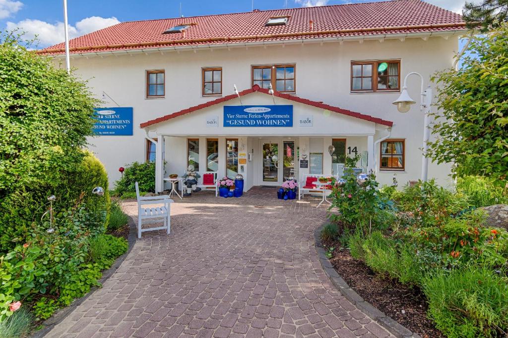 a large white building with a sign in front of it at KaLü Apartments in Braunlage